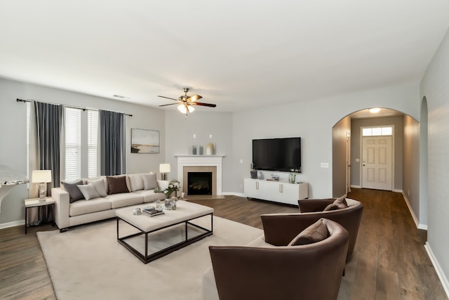 living room featuring dark hardwood / wood-style floors and ceiling fan