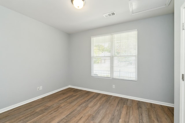 unfurnished room with dark hardwood / wood-style flooring