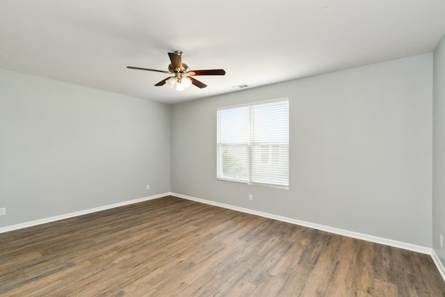 unfurnished room with ceiling fan and dark wood-type flooring