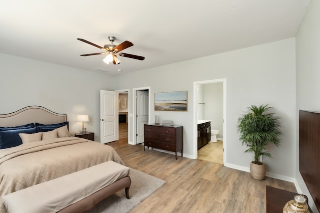 bedroom featuring ensuite bathroom, ceiling fan, and light hardwood / wood-style floors