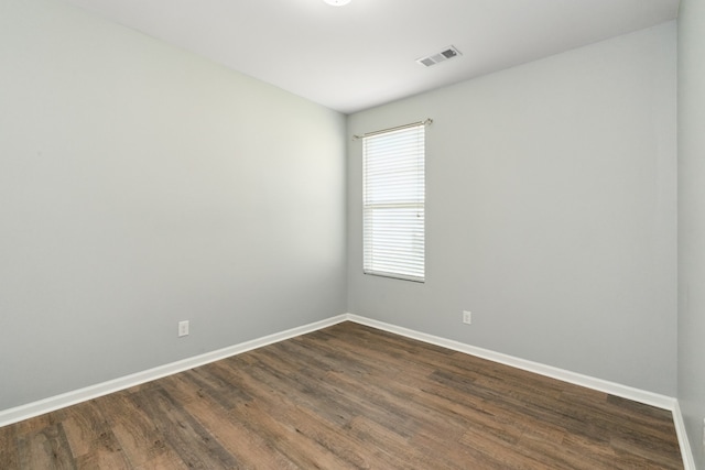 empty room featuring dark hardwood / wood-style flooring