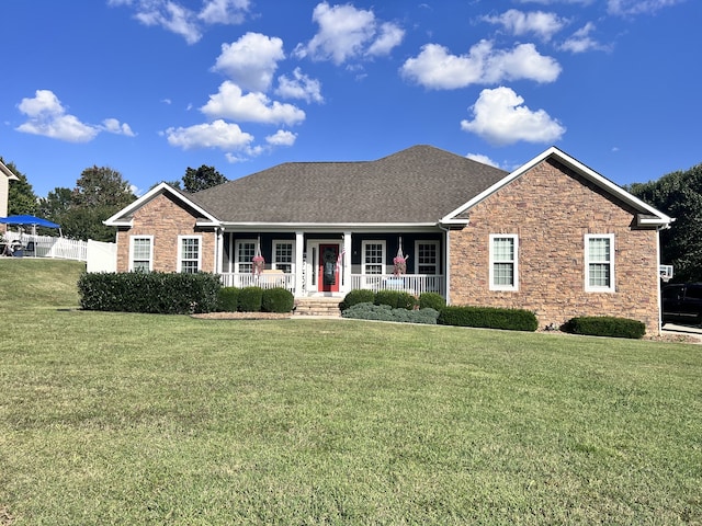 ranch-style house with a front yard and a porch