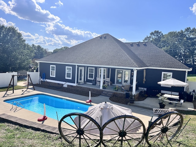 view of pool featuring french doors and a patio area