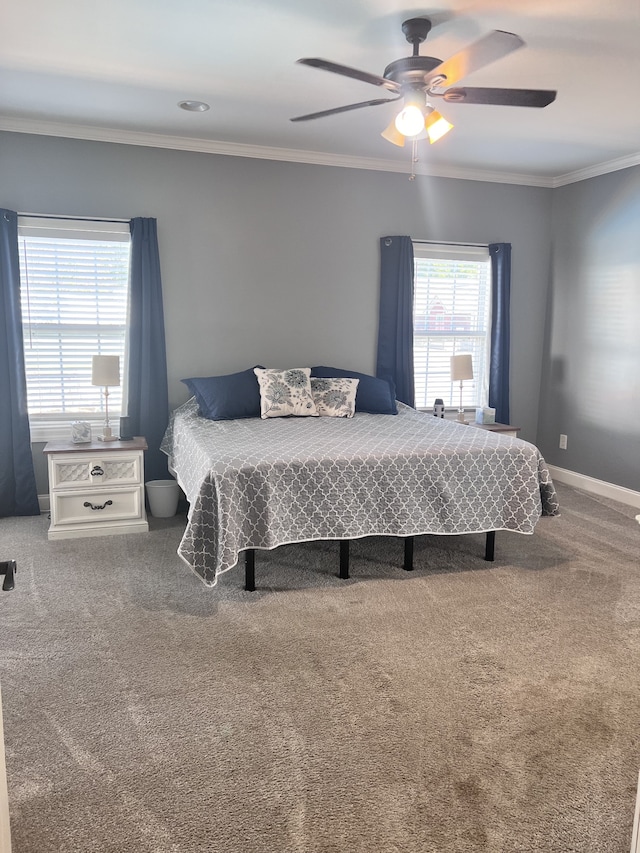 carpeted bedroom featuring ceiling fan and ornamental molding