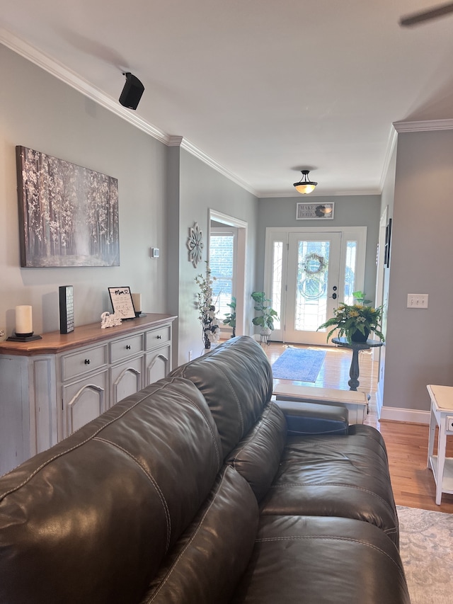 living room with light hardwood / wood-style floors and ornamental molding