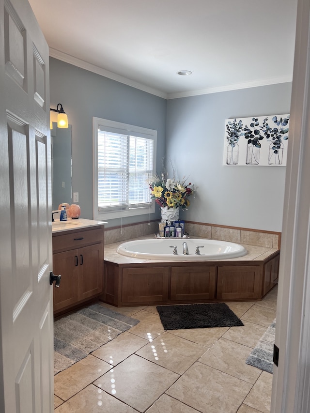 bathroom featuring tile patterned flooring, vanity, a bathing tub, and ornamental molding