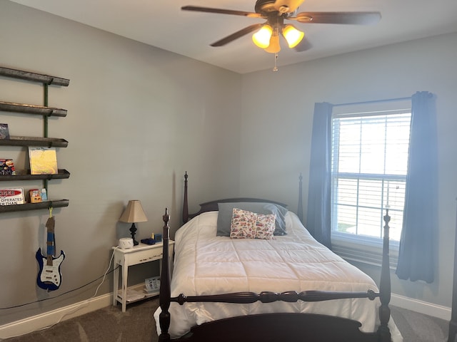 bedroom featuring ceiling fan and dark carpet