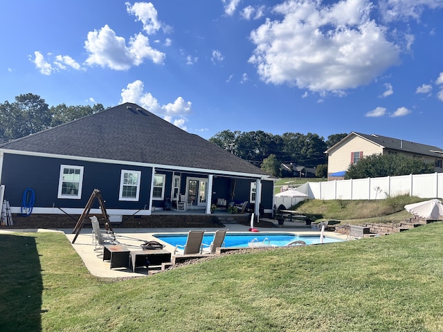 view of swimming pool featuring a lawn, french doors, and a patio