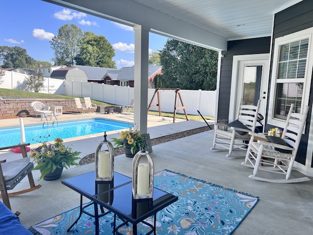 view of swimming pool featuring a patio area