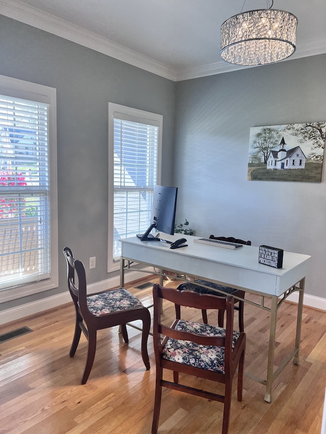 office space with a chandelier, light hardwood / wood-style floors, and ornamental molding