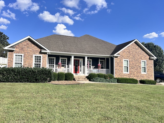 view of front of house featuring covered porch and a front lawn