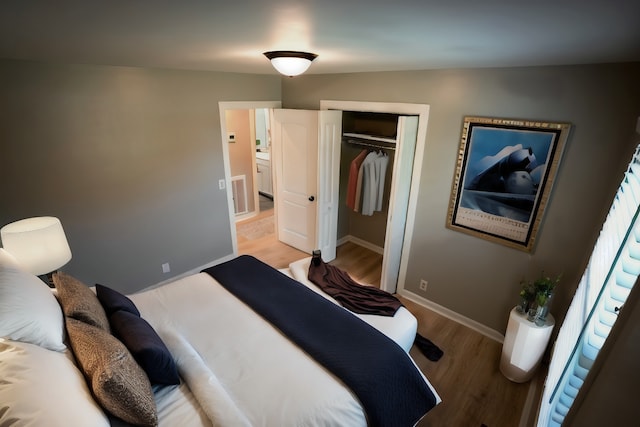 bedroom with light hardwood / wood-style flooring and a closet