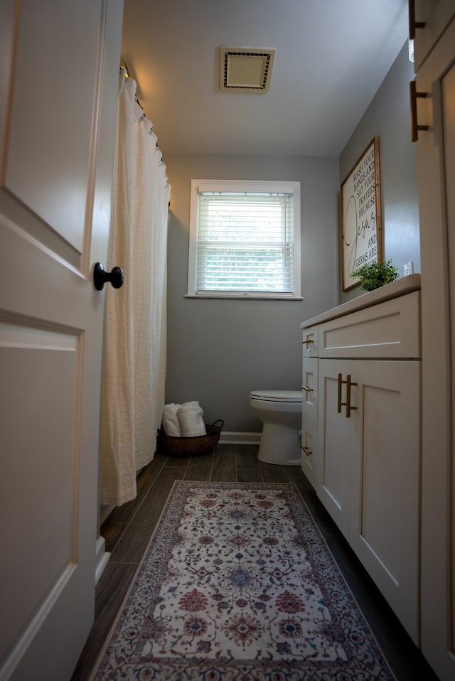 bathroom featuring vanity and toilet