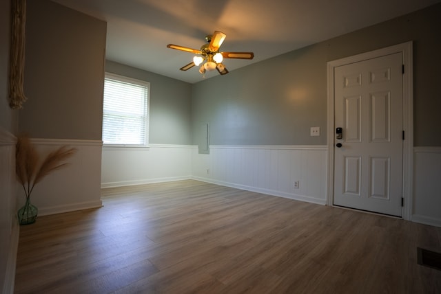 unfurnished room with hardwood / wood-style floors and ceiling fan