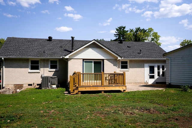 rear view of house featuring a yard, central AC unit, a patio area, and a wooden deck