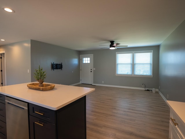 kitchen featuring dark hardwood / wood-style flooring, ceiling fan, dishwasher, and a kitchen island