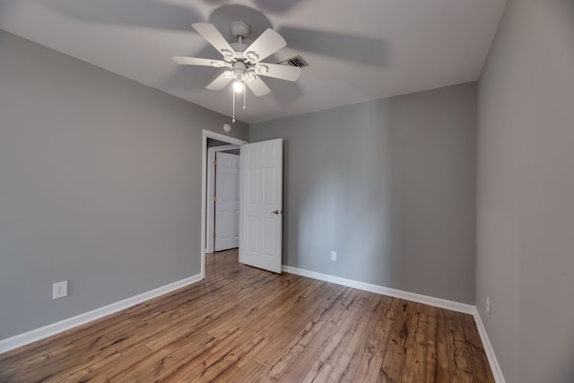 spare room featuring ceiling fan and light wood-type flooring