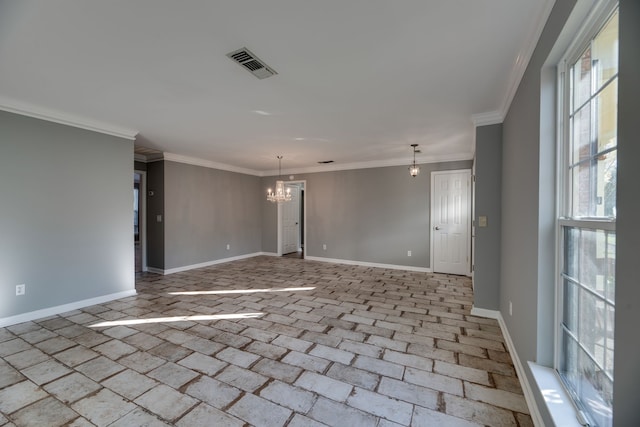 empty room with a chandelier and crown molding