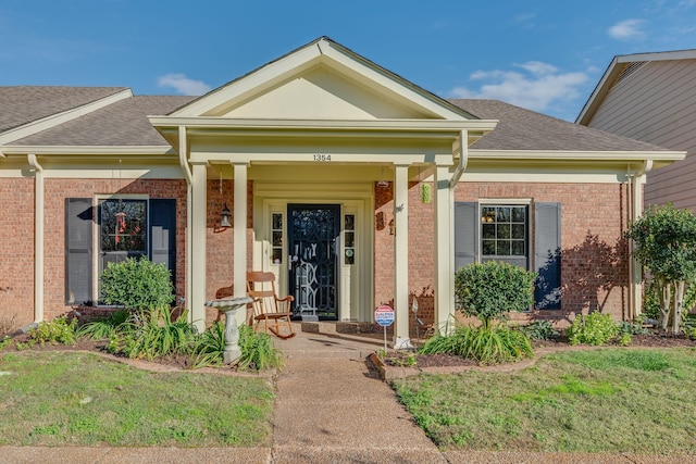 view of exterior entry featuring a yard