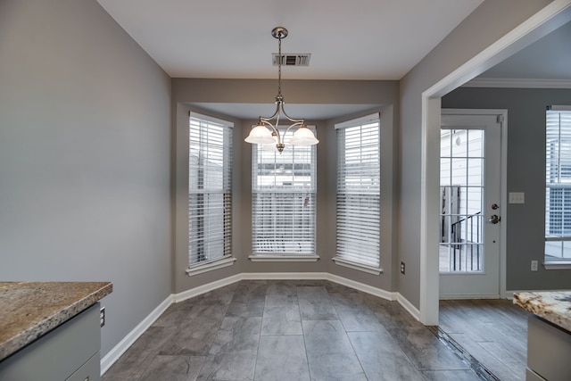 unfurnished dining area with crown molding, hardwood / wood-style floors, and a healthy amount of sunlight