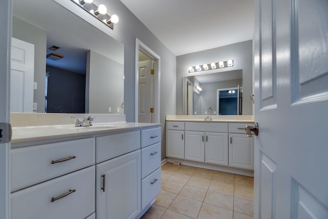 bathroom featuring tile patterned flooring and vanity