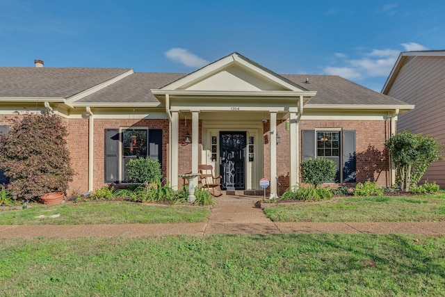 neoclassical / greek revival house with a front lawn