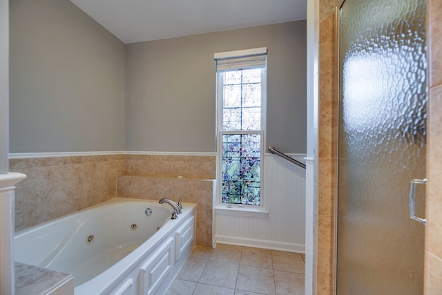 bathroom featuring tile patterned flooring and a bath