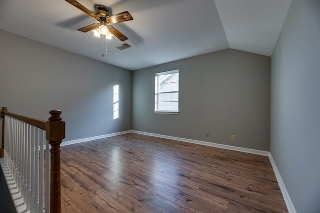 spare room featuring vaulted ceiling, ceiling fan, and dark hardwood / wood-style floors