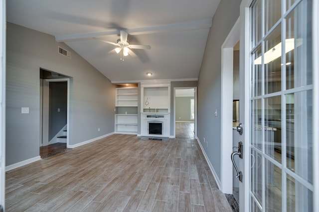 unfurnished living room with ceiling fan, plenty of natural light, lofted ceiling, and light wood-type flooring