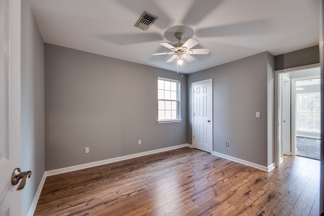 spare room with hardwood / wood-style flooring and ceiling fan