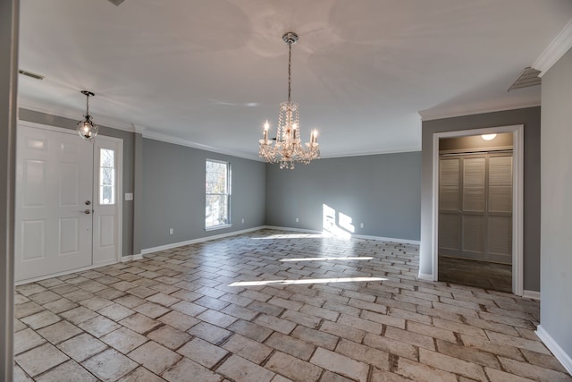 interior space featuring ornamental molding and a notable chandelier