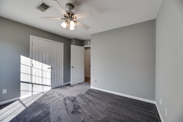 unfurnished bedroom with ceiling fan, a closet, and carpet floors