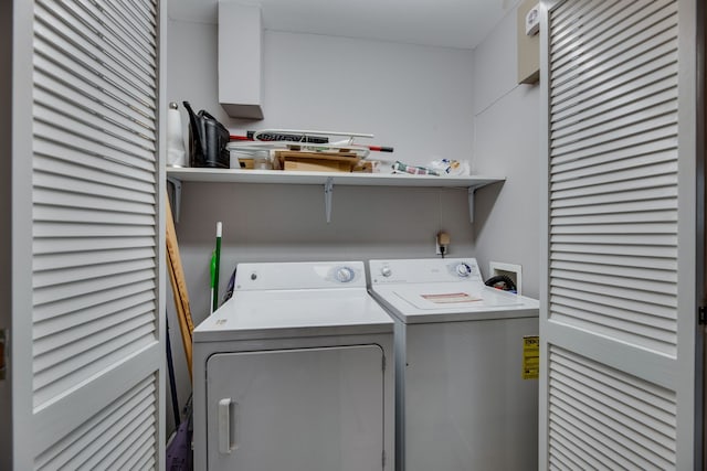 clothes washing area with washer and dryer