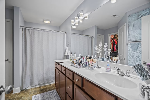 bathroom featuring vanity and curtained shower