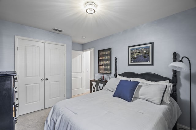 bedroom with light colored carpet and a closet