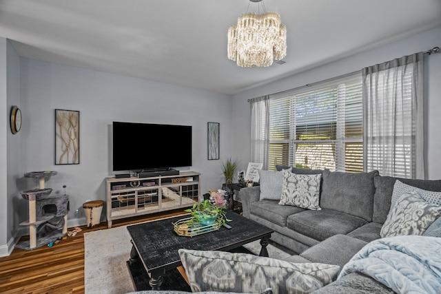 living room featuring a notable chandelier and wood-type flooring