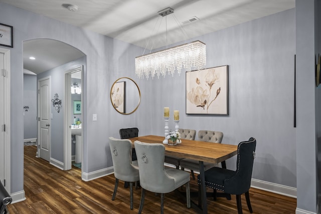 dining area featuring a chandelier and dark hardwood / wood-style floors