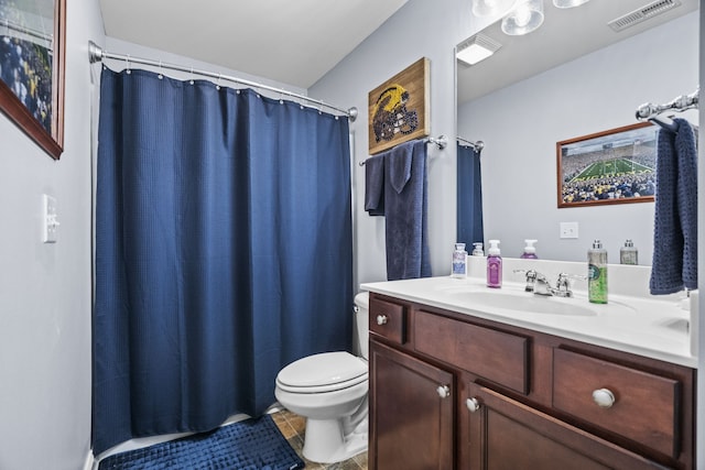 bathroom with tile patterned flooring, vanity, and toilet