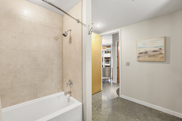 bathroom featuring tiled shower / bath and concrete floors