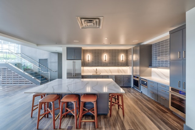 dining space with sink and dark wood-type flooring