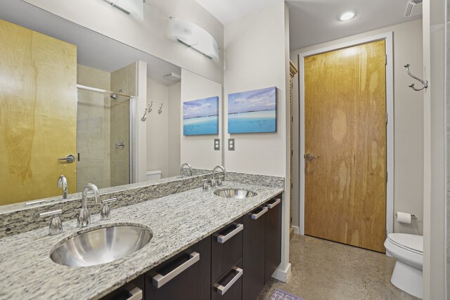 bathroom with vanity, toilet, and an enclosed shower