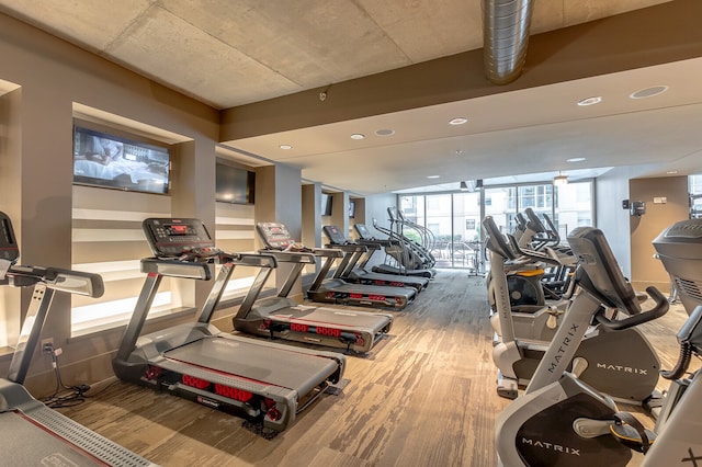 exercise room featuring hardwood / wood-style flooring and a wall of windows