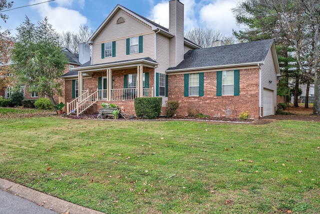 view of front facade with covered porch, a front yard, and a garage