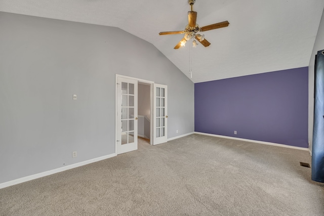 unfurnished room with ceiling fan, vaulted ceiling, carpet floors, and french doors