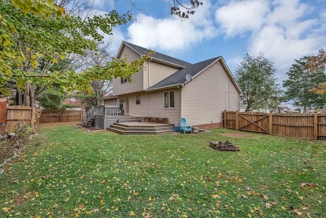 back of property featuring a lawn and a wooden deck