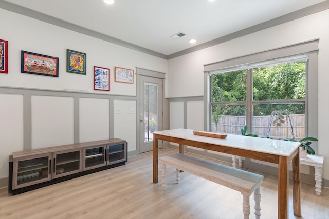 office area with light hardwood / wood-style floors and crown molding