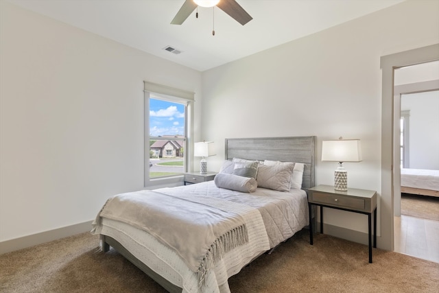 bedroom featuring ceiling fan and carpet