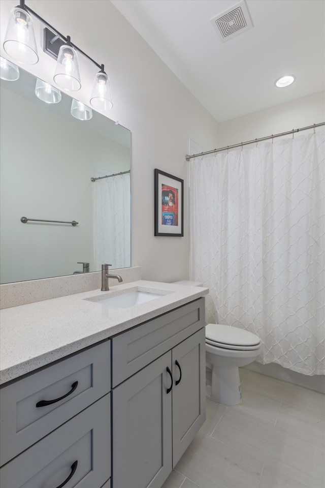 bathroom featuring tile patterned flooring, vanity, and toilet