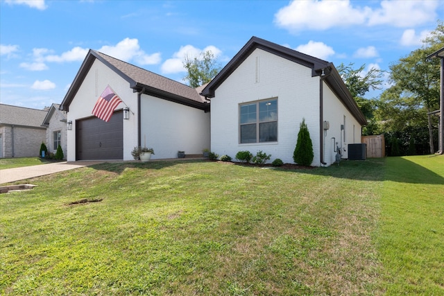 view of front of home with a garage, central air condition unit, and a front lawn