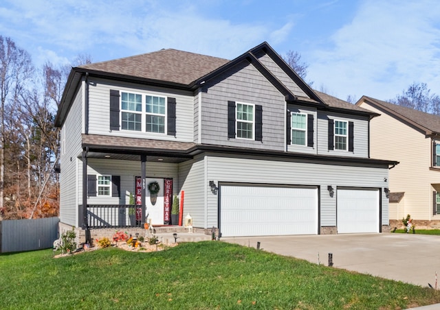 view of front facade featuring a porch, a front yard, and a garage